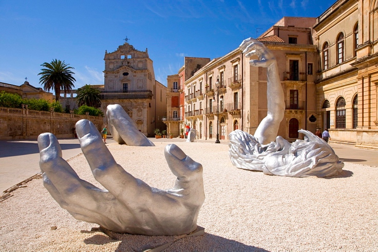 Modern Art by Seward Johnson "The Awaking", Piazza Duomo square, cathedral on Ortigia island, the old town of Syracuse, Sicily, Italy, Europe